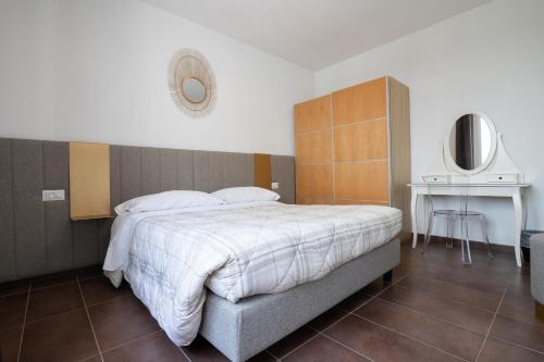 a bedroom with a large bed and a table at Villa Liliana in Cervia