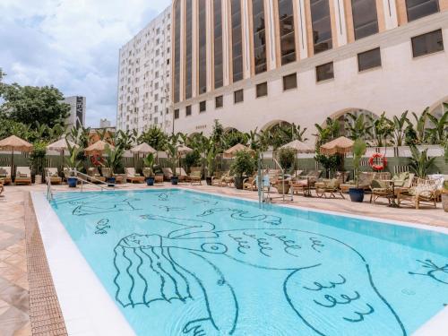 a pool with a painting on the side of a hotel at Only YOU Hotel Sevilla in Seville