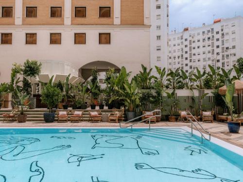 a swimming pool on the rooftop of a hotel at Only YOU Hotel Sevilla in Seville