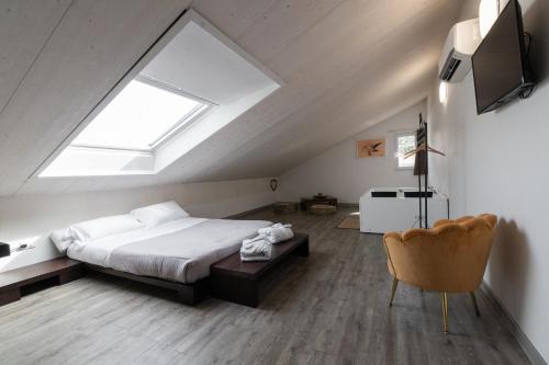 a attic bedroom with a bed and a skylight at Villa Liliana in Cervia