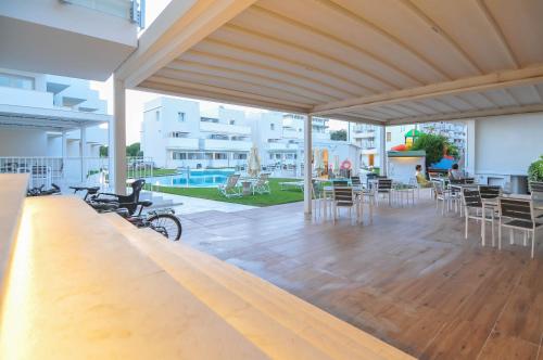 a pavilion with chairs and tables and a pool at Marina Palace Hotel 4 stelle S in Caorle