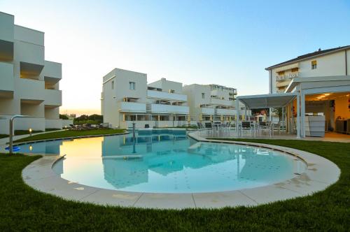 a large swimming pool in front of a building at Marina Palace Hotel 4 stelle S in Caorle