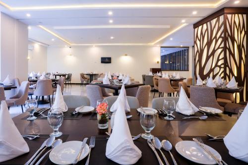 Un comedor con mesas y sillas en un restaurante. en Avari Xpress Skardu, en Skardu