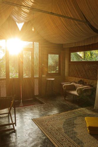 a living room with a couch and a table at Monsoon Eco Resort - Whisky point Arugambay in Pottuvil