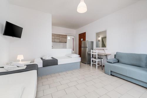 a living room with a bed and a couch at Katerina's Garden Mola Kaliva in Mola Kalyva