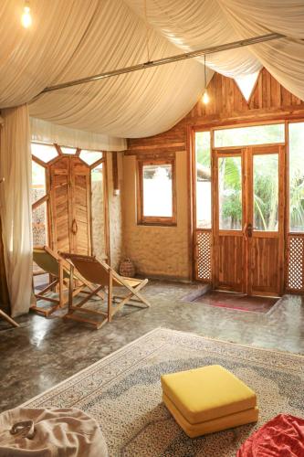 a room with a tent with a yellow mattress in it at Monsoon Eco Resort - Whisky point Arugambay in Pottuvil