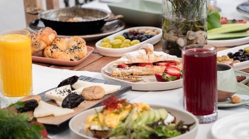 a table topped with plates of food and drinks at Nadas Kazdağları in Canakkale