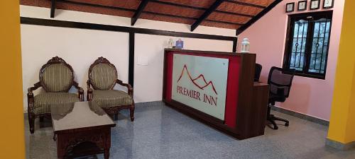 a sign in a room with two chairs and a podium at Premier Inn in Yercaud