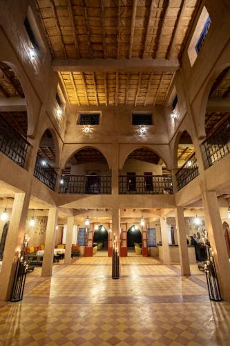 an empty lobby with a large building with a ceiling at Kanz Erremal in Merzouga