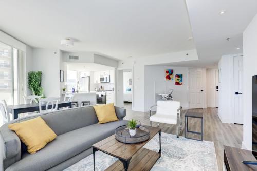 a living room and kitchen with a couch and a table at Jetsetter's 2BR Hub Between DC & Airport in Arlington
