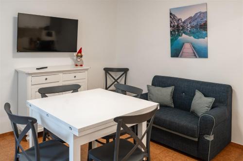 a living room with a table and a couch at Rustico Porta in Brissago