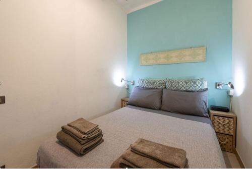 a bedroom with a bed with two towels on it at Casa Vacanze L'Aquilone - casa sulla spiaggia - baia di Porto Rafael in Palau