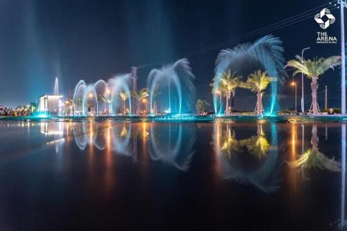 a water fountain in the middle of a city at night at The KH Cam Ranh Nha Trang Beachside in Thôn Hòa Ða
