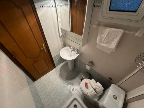 a small bathroom with a toilet and a sink at Home for you Halkidiki in Kallithea Halkidikis