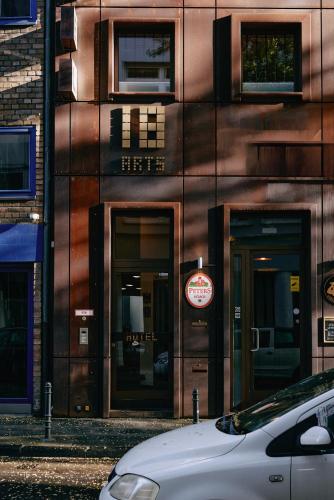 a building with two revolving doors on a city street at 18Arts Hotel - Living in a Gallery! in Cologne