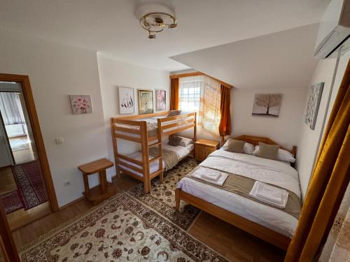 a bedroom with two beds and a window at Sarajevo Villa Ruza Vjetrova in Vinogradi