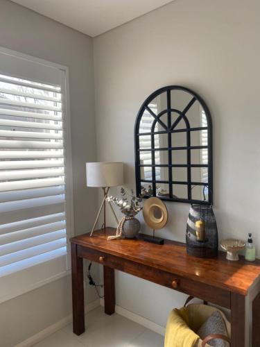 a room with a table with a lamp and a window at 4 bedroom family home in Riverwood in Riverwood