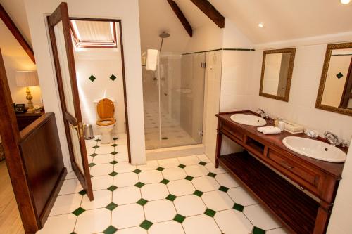 a bathroom with two sinks and a shower at Hotel du Vin Franschhoek in Franschhoek