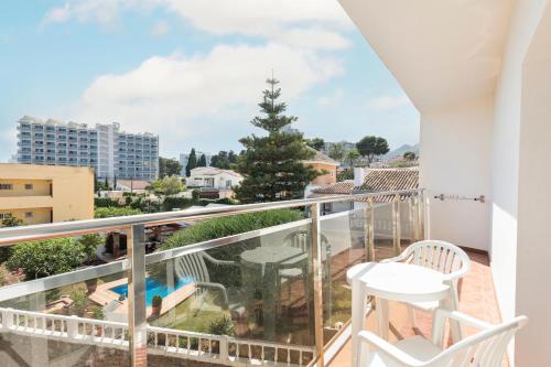 a balcony with a table and chairs and a christmas tree at Hotel Best Siroco in Benalmádena