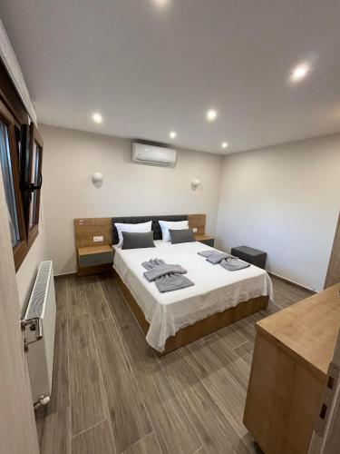 a bedroom with a large bed in a room at Victoria's Apartments in Nea Plagia