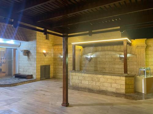 a room with a brick wall with a fireplace at شقة بروف خارجي in Cairo