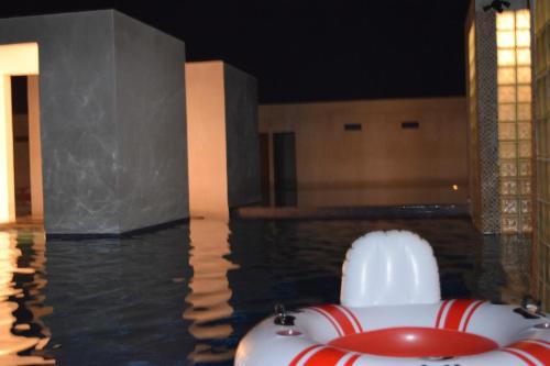a pool of water with a red and white raft at Hotel Maya Jade in Monterrico