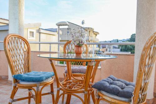 a table and chairs sitting on a balcony at Rexha Apartments in Ulcinj