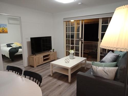 a living room with a couch and a table at Modern 2BR Apartment and Parking in Griffith - Hosted by Canstay in Kingston 
