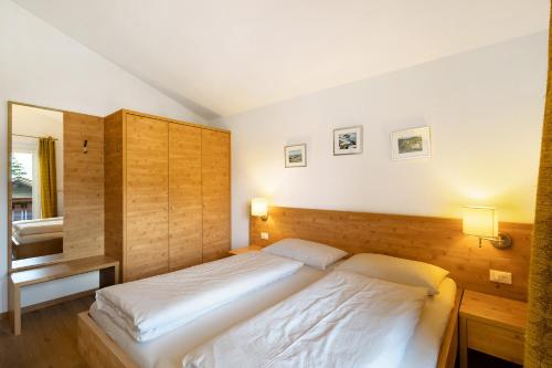 a bedroom with a large white bed in it at Kriendl Nr 3 in Valdaora
