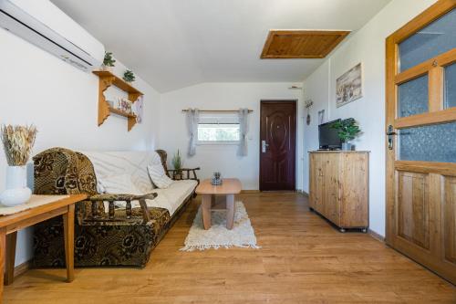 a living room with a couch and a table at Apartmány MOKO in Podhájska