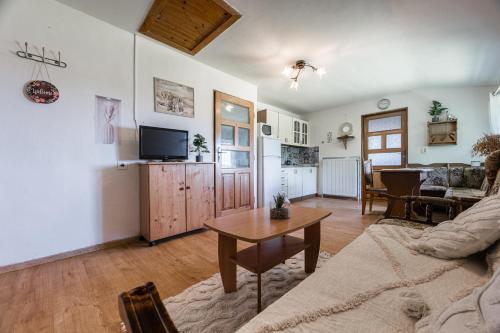 a living room with a couch and a table at Apartmány MOKO in Podhájska