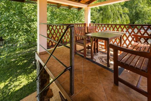 a porch with a table and chairs on it at Apartmány MOKO in Podhájska