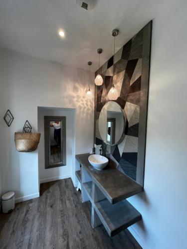 a bathroom with a sink and a mirror at Villavos- Le Bocage in Cassis