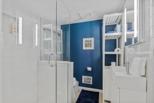 a bathroom with a blue wall and a toilet and a sink at Heart Of Dupont and Walk to Georgetown in Washington, D.C.