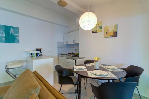 a living room with a table and chairs and a kitchen at Vila DADA 2 in Senj