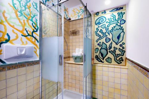 a shower with a glass door in a bathroom at Estate4home - Casa Nonna Mary in Positano