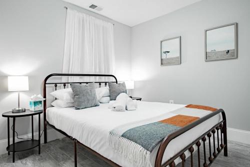a white bedroom with a large bed and a window at Central DC Flat Sleeps 3 Convention Center in Washington, D.C.