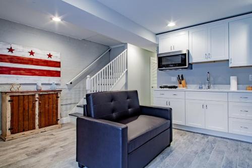 a living room with a chair and an american flag on the wall at Central DC Flat Sleeps 3 Convention Center in Washington, D.C.