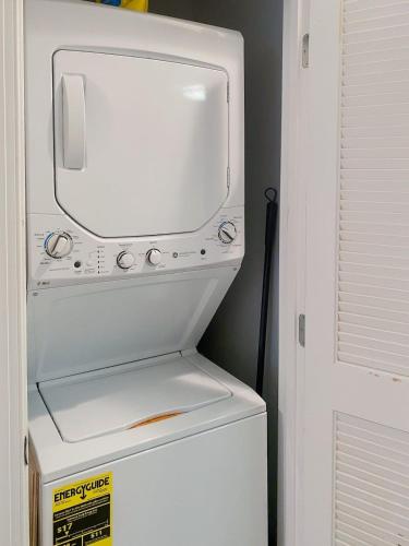 a white refrigerator with a tv on top of it at Central DC Flat Sleeps 3 Convention Center in Washington, D.C.