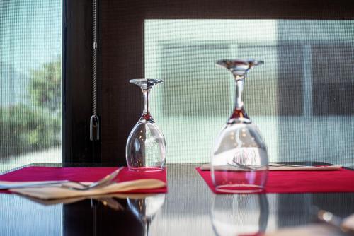 two wine glasses sitting on top of a table at Hotel Cim Valles in Santa Perpetua de Moguda