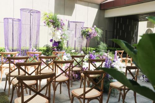 a row of chairs in a room with flowers at voco Wuhan Xinhua by IHG in Wuhan