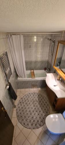 a bathroom with a tub and a sink and a toilet at The terraced house in Stockholm
