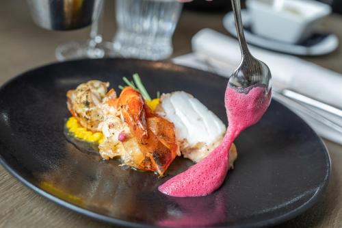 a plate of food with a fork on a table at Hotel Post in Kaltenbach