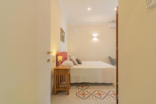 a small bedroom with a bed and a table at Lake Lovers Lodge in Montefiascone
