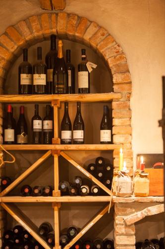 a bunch of bottles of wine sitting on a shelf at Hotel Comfort Erica Dolomiti Val d'Adige in Salorno sulla Strada del Vino
