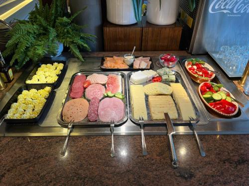 a buffet with meats and cheese and other foods at Landhotel Georgshof in Hünfeld