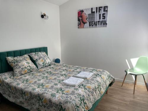 a bedroom with a bed with a poster on the wall at Maison avec piscine en centre ville in Vendôme