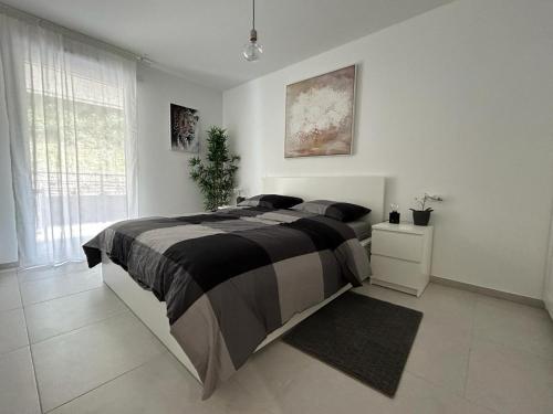 une chambre avec un grand lit et une fenêtre dans l'établissement Fabron Hills, à Nice