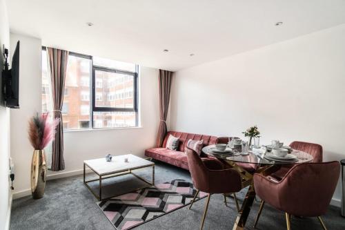 a living room with a red couch and a table at Lovely 1 Bed Central Preston Apartment in Preston