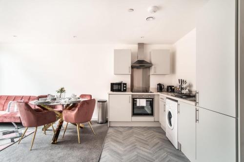a kitchen and dining room with a table and chairs at Lovely 1 Bed Central Preston Apartment in Preston